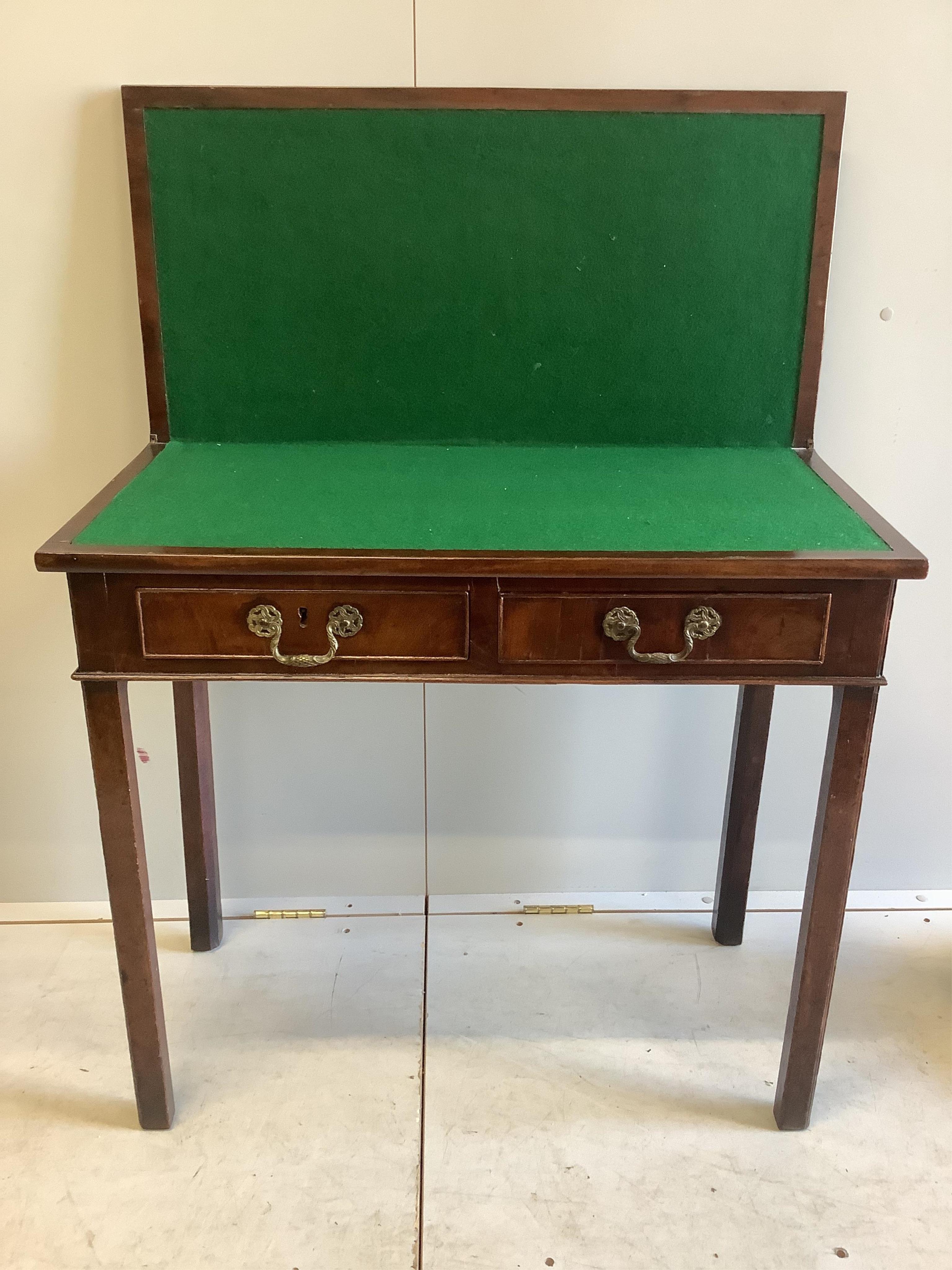 A George III rectangular mahogany folding card table, width 84cm, depth 41cm, height 76cm. Condition - fair